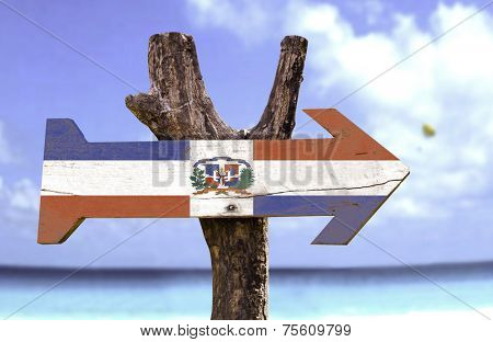 Dominican Republic wooden sign with a beach on background 