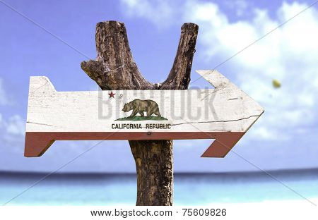 California State wooden sign with a beach on background 