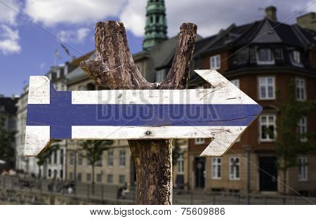 Finland wooden sign with a city background