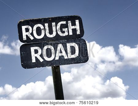 Rough Road sign with clouds and sky background 