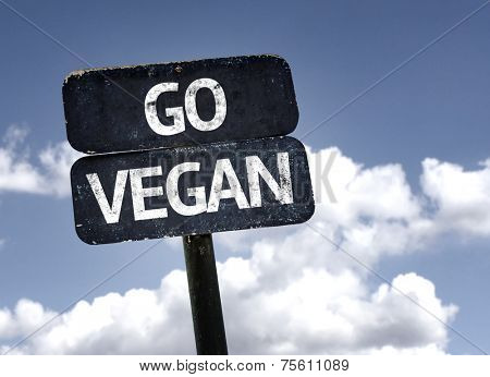Go Vegan sign with clouds and sky background 