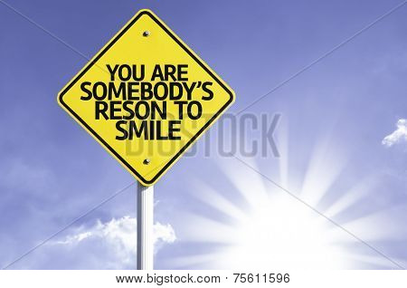 You Are Somebody's Reason to Smile road sign with sun background 
