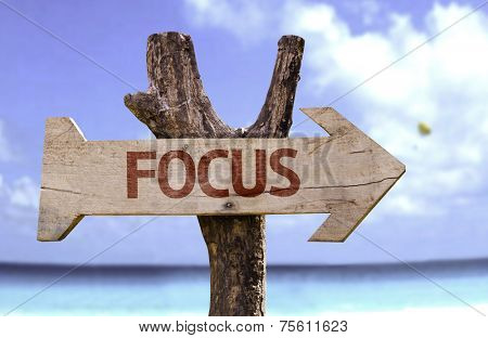 Focus sign with a beach on background 