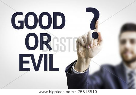 Business man pointing to transparent board with text: Good or Evil?