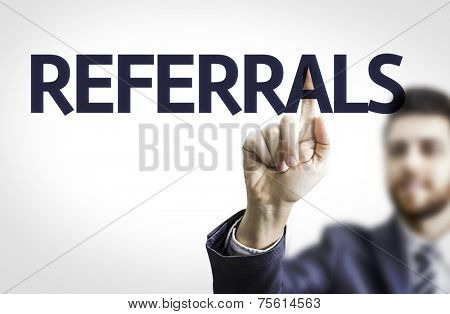 Business man pointing to transparent board with text: Referrals
