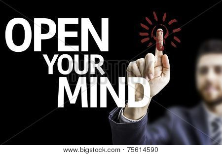 Business man pointing to black board with text: Open your Mind