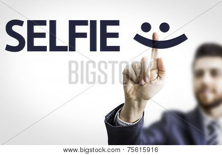 Business man pointing to transparent board with text: Selfie