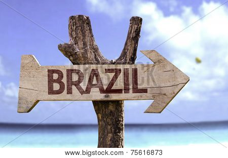 Brazil wooden sign with a beach on background