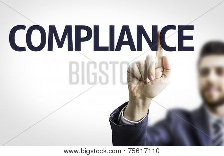 Business man pointing to transparent board with text: Compliance