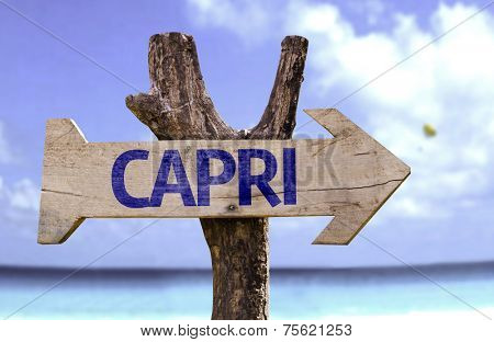 Capri wooden sign with a beach on background
