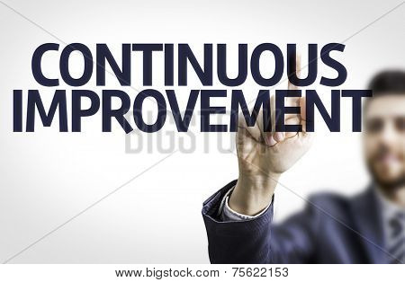 Business man pointing to transparent board with text: Continuos Improvement