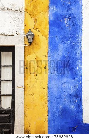 Picturesque yellow and blue wall, Obidos, Portugal