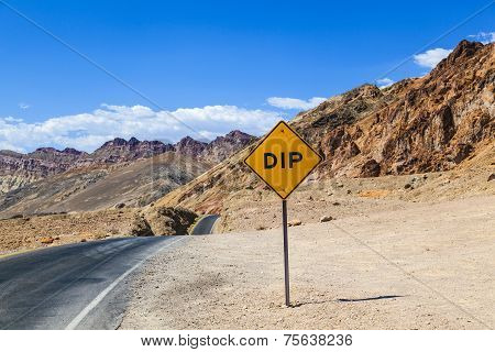 Scenic Road Artists Drive In Death Valley With Colorful Stones, Hills With Minerals,  Road Sign Dip