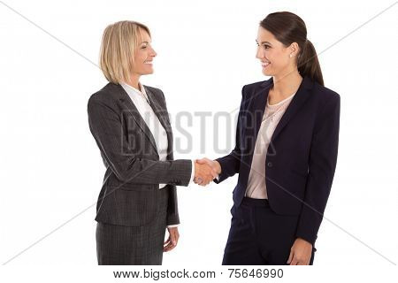Team: Two isolated businesswoman shaking hands wearing business outfit 