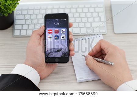 Businessman Holding Iphone 6 Space Gray With News Applications