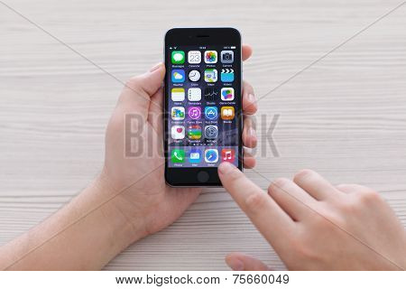 Man Holding Iphone 6 Space Gray Over The Table