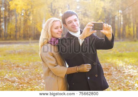 Love, Relationship, Technology And People Concept - Happy Smiling Couple In Love Making Selfie Outdo