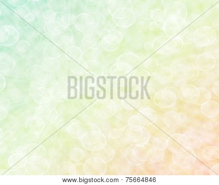 Abstract Boken Background In Light Yellow, Orange And Green Shades.