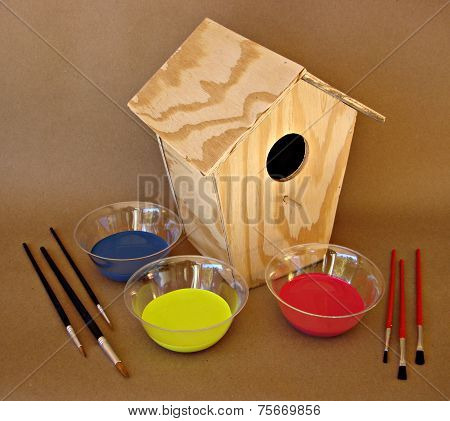 wooden birdhouse and paints