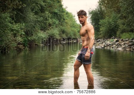 Handsome Young Muscle Man Standing In Water