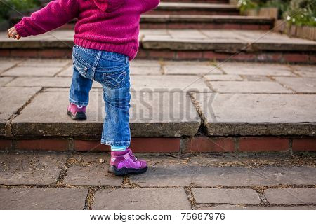 Baby girl climbing steps