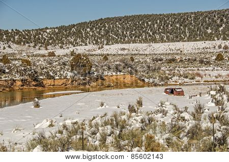 Rusty Vehicle Partially Buried in Snow