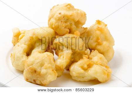 Florets of cauliflower parboiled then dipped in batter and deep fried