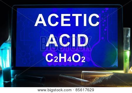 Tablet with chemical formula of  acetic acid.