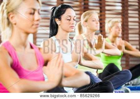 Practicing yoga in gym