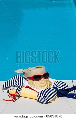utensils for a nice relaxing vacation day lying next to a swimming pool. relaxation on vacation.
