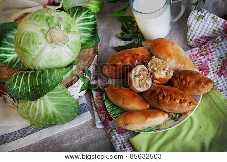 rustic still life with pies, cabbage and milk