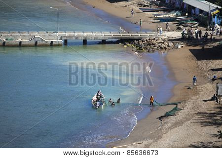 SOUFRIERE, ST LUCIA-MARCH 3, 2011: Unidentified people take in nets and sell fish along the waterfront in Soufriere, St Lucia