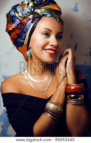 beauty bright african woman with creative make up, shawl on head