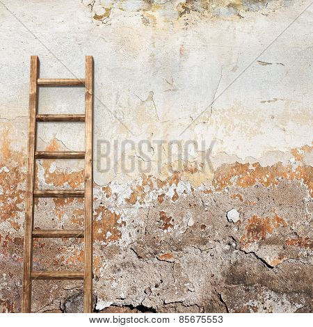 weathered stucco wall with wooden ladder