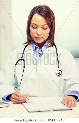 medicine and healthcare concept - busy doctor with laptop computer