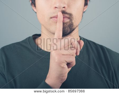 Man With Half Beard And Finger On Lips