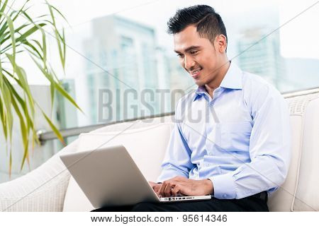 Businessman working with laptop from home being a telecommuter