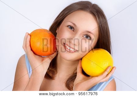 Portrait Of Pretty Young Beautiful Woman With Two Grapefruits In Her Hands. Healthcare. Healthy Life