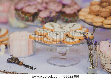 Dessert table for a wedding party. Biscuits decorated with lavanda flowers