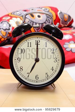 Ringing Alarm Clock And Empty Bed In Background