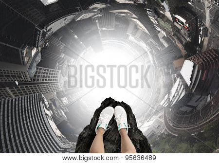 Close up of woman legs standing on the edge of rock