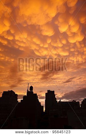 Manhattan Buildings In Silhouette With Orange Mammatus Clouds At Sunset