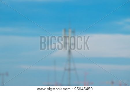 Blurred Communication Tower On Blue Sky Background.