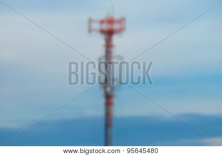 Blurred Communication Tower On Blue Sky Background.