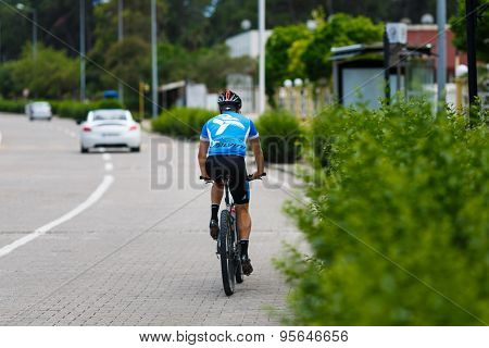 Lonely Cyclist Riding Bicycle