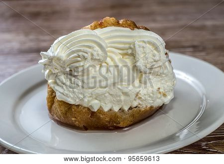 Savarin with whipped cream placed on a plate