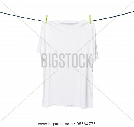 Close Up Of A White T-shirt On The Rope. Isolated On White Background.