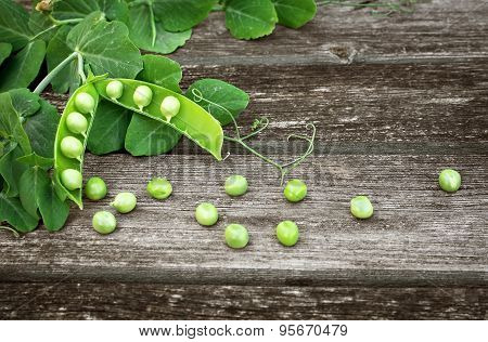 Peas on wooden background