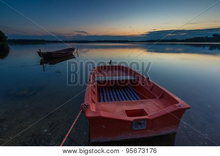 Beautiful Lake Sunset With Fisherman Boats