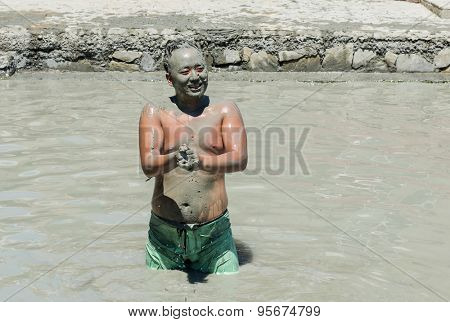 SULTANIYE, TURKEY - JULY 05, 2015: Man taking a mud bath.